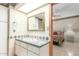 Bathroom featuring a vanity sink, tile counters and flooring, and a doorway to a bedroom at 8043 E Laurel St, Mesa, AZ 85207