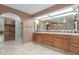 Spacious bathroom with double vanity, tile floors, large mirror, and a walk-in shower visible at 8043 E Laurel St, Mesa, AZ 85207