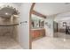 Bathroom featuring arched doorways leading to shower and vanity, complemented by tile flooring at 8043 E Laurel St, Mesa, AZ 85207