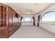 Spacious bedroom with built-in storage and large arched windows offering plenty of natural light and neighborhood views at 8043 E Laurel St, Mesa, AZ 85207