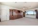 Bright bedroom featuring built-in wood storage, neutral carpet, and large arched windows showcasing desert views at 8043 E Laurel St, Mesa, AZ 85207