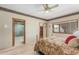 Bedroom featuring a ceiling fan, window with a view, and doorways to other rooms at 8043 E Laurel St, Mesa, AZ 85207