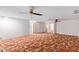 Spacious bedroom with mirrors on the closet doors and vintage carpet with large open space at 8043 E Laurel St, Mesa, AZ 85207
