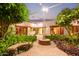 Beautiful courtyard with desert landscaping, unique water feature and access to multiple rooms in the home at 8043 E Laurel St, Mesa, AZ 85207
