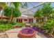 Lush courtyard area with mature trees and plants and a covered, skylighted roof at 8043 E Laurel St, Mesa, AZ 85207