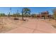 Long driveway leading to an impressive hacienda-style home with mature landscaping and desert vegetation at 8043 E Laurel St, Mesa, AZ 85207
