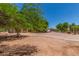 Sprawling estate with a large parking area and mature trees, creating a serene and private setting at 8043 E Laurel St, Mesa, AZ 85207