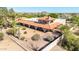 An exterior shot of a desert home featuring stucco walls, arched veranda, and desert landscaping at 8043 E Laurel St, Mesa, AZ 85207