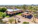 An exterior shot of a desert home featuring guest house, circular driveway, lush lawn, and stucco walls at 8043 E Laurel St, Mesa, AZ 85207