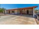 Exterior view of home featuring a covered patio, desert landscaping, and concrete driveway at 8043 E Laurel St, Mesa, AZ 85207