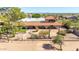 An exterior shot of a desert home showing the native desert landscaping, gated entrance, and tiled roof at 8043 E Laurel St, Mesa, AZ 85207