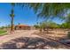 Attractive property showcasing mature palm trees, lush landscaping, and a circular driveway leading to the home at 8043 E Laurel St, Mesa, AZ 85207