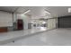 A large, well-lit garage with ample space, storage cabinets, and a roll-up door at 8043 E Laurel St, Mesa, AZ 85207
