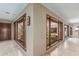 Hallway with tile flooring and large picture windows overlooking a charming outdoor garden space at 8043 E Laurel St, Mesa, AZ 85207