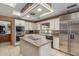 Gourmet kitchen featuring an island cooktop, stainless steel fridge, and tile flooring at 8043 E Laurel St, Mesa, AZ 85207