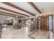 Spacious living room with stone accent wall, wood beams, and decorative tile flooring and entryway at 8043 E Laurel St, Mesa, AZ 85207