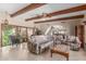 Spacious living room with beamed ceilings, tile flooring, and comfortable seating arrangement with great natural light at 8043 E Laurel St, Mesa, AZ 85207