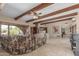 Inviting living room featuring beamed ceilings, tile flooring, and comfortable seating with natural light at 8043 E Laurel St, Mesa, AZ 85207