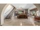 Open living room with a staircase, tile flooring, stone fireplace, and large windows offering plenty of natural light at 8043 E Laurel St, Mesa, AZ 85207
