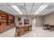 Large office with custom wood built-ins, a large desk, and tiled flooring at 8043 E Laurel St, Mesa, AZ 85207
