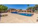Expansive pool area with desert landscaping and a covered patio, ideal for outdoor entertaining at 8043 E Laurel St, Mesa, AZ 85207