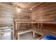 Relaxing sauna room featuring wood paneled walls, a built-in bench, and a traditional heater at 8043 E Laurel St, Mesa, AZ 85207