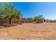 Expansive dirt lot with storage buildings at 8043 E Laurel St, Mesa, AZ 85207