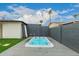 Backyard featuring a swim spa and enclosed by gray brick walls at 8252 E Heatherbrae Ave, Scottsdale, AZ 85251
