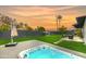 Spacious backyard featuring a hot tub, grill, and outdoor seating against a picturesque sky at 8252 E Heatherbrae Ave, Scottsdale, AZ 85251