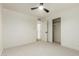 Clean bedroom with a ceiling fan, carpet, and a closet with sliding doors at 8252 E Heatherbrae Ave, Scottsdale, AZ 85251