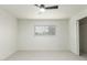 Bright bedroom with ceiling fan, blinds on the window, and closet with sliding doors at 8252 E Heatherbrae Ave, Scottsdale, AZ 85251
