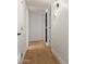 Hallway featuring hardwood floors, white walls, and modern lighting fixture at 8252 E Heatherbrae Ave, Scottsdale, AZ 85251