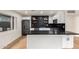 Modern kitchen with sleek black countertops, white cabinets, and stainless steel appliances at 8252 E Heatherbrae Ave, Scottsdale, AZ 85251