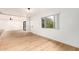 Bright living space with light wood floors that connect to a door to the backyard and a large window at 8252 E Heatherbrae Ave, Scottsdale, AZ 85251