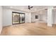 Bright living room featuring light wood floors, large sliding glass doors, and modern lighting at 8252 E Heatherbrae Ave, Scottsdale, AZ 85251