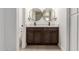 Bathroom with dual sinks, a dark wood vanity, and modern fixtures at 862 W Javelina Ave, Mesa, AZ 85210