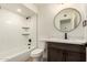 Bright bathroom features a tub with white subway tile, modern fixtures, and a dark wood vanity at 862 W Javelina Ave, Mesa, AZ 85210