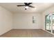 This bedroom features a ceiling fan, window, and sliding glass doors at 862 W Javelina Ave, Mesa, AZ 85210