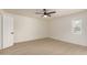 A simple bedroom features a ceiling fan, window, and closet at 862 W Javelina Ave, Mesa, AZ 85210