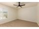 Bedroom with large window, modern ceiling fan, and neutral decor at 862 W Javelina Ave, Mesa, AZ 85210