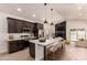 Modern kitchen featuring a large island with seating, stainless steel appliances, and views of the pool at 862 W Javelina Ave, Mesa, AZ 85210