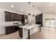 Modern kitchen with white countertops, stainless appliances, and an island in an open floor plan at 862 W Javelina Ave, Mesa, AZ 85210