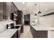 Modern kitchen with white countertops, stainless appliances, and a large center island at 862 W Javelina Ave, Mesa, AZ 85210