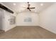 A spacious, empty living room featuring wood-style flooring, modern lighting, and large windows at 862 W Javelina Ave, Mesa, AZ 85210