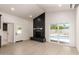 Spacious living room featuring a modern fireplace, sliding glass doors, and hardwood flooring at 862 W Javelina Ave, Mesa, AZ 85210
