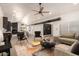 Virtually staged open-concept living room with neutral furniture and a modern ceiling fan at 862 W Javelina Ave, Mesa, AZ 85210