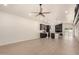 Empty living room featuring wood-style flooring, updated lighting, a ceiling fan, and a kitchen view at 862 W Javelina Ave, Mesa, AZ 85210