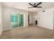This room features a ceiling fan, ensuite bathroom, and sliding glass doors at 862 W Javelina Ave, Mesa, AZ 85210