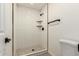 Tiled shower with a stone shower floor, floating shelves, and modern fixtures at 862 W Javelina Ave, Mesa, AZ 85210