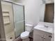 Bathroom featuring a shower with sliding door, toilet, sink, and a vanity at 8940 W Olive Ave # 39, Peoria, AZ 85345
